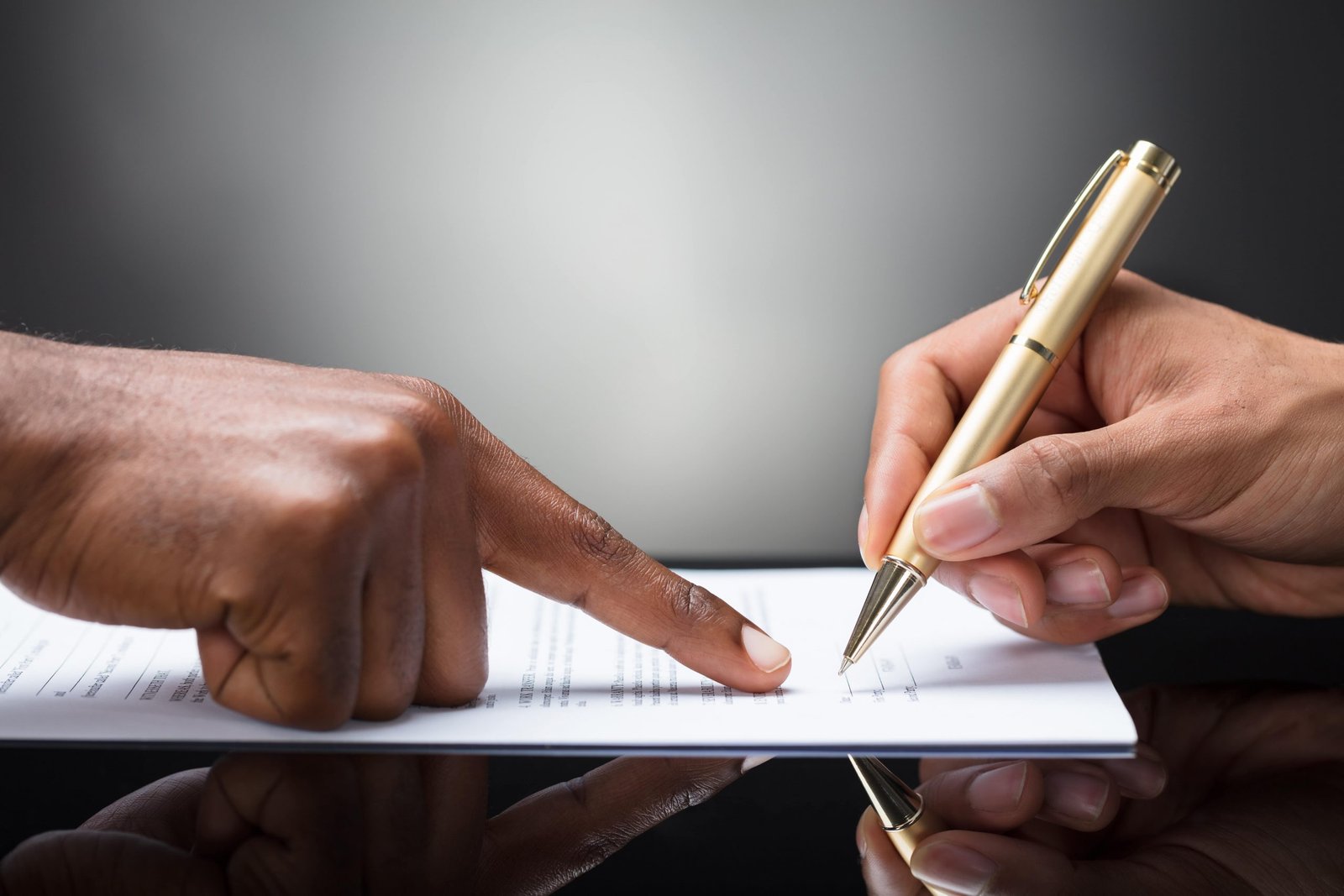 Business Borrowing Concept – Finger Pointing In Front Of A Person Signing With Golden Pen On The Document